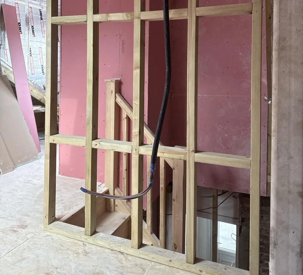Timber partition framing around an interior stairwell.