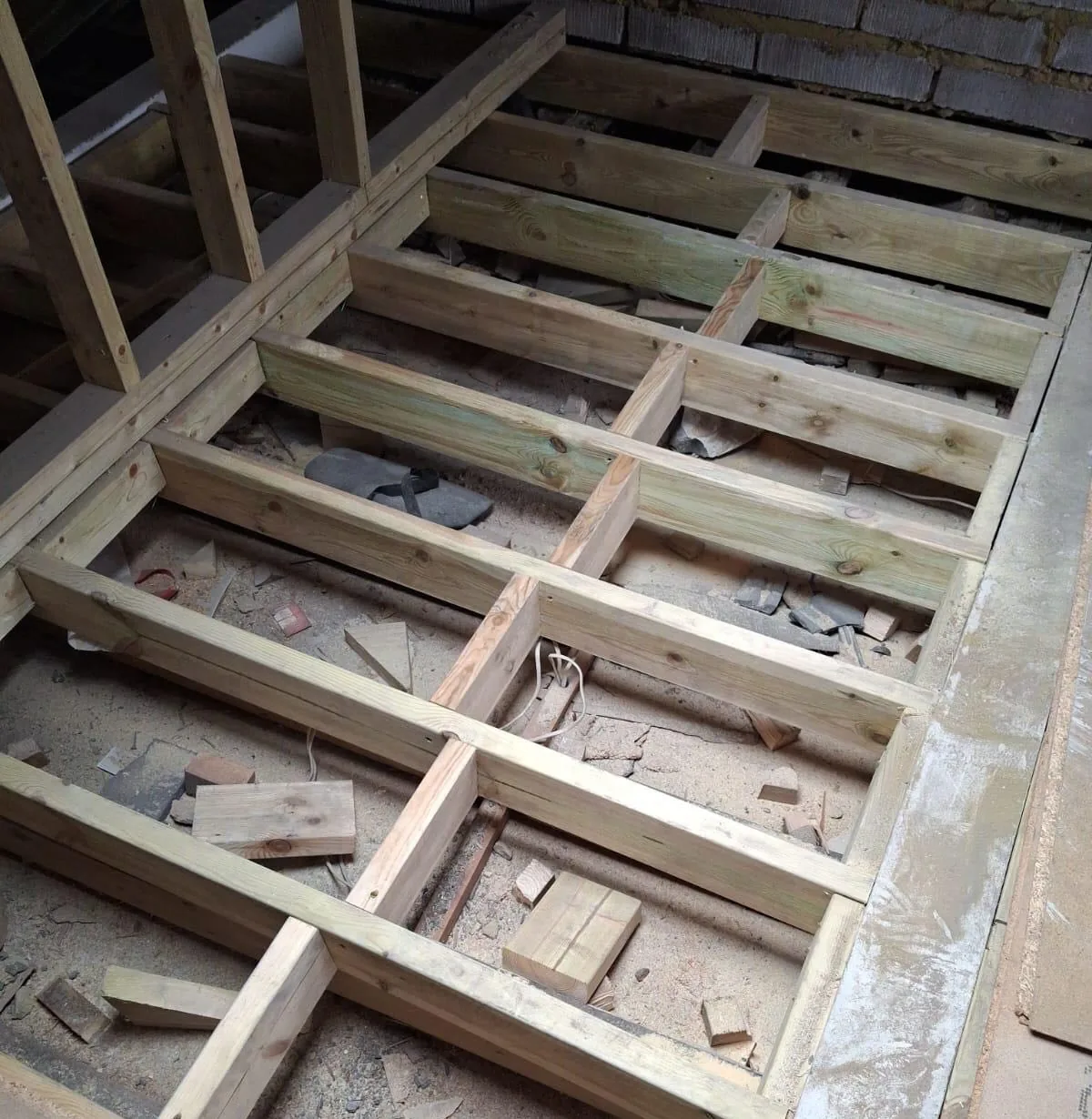 Timber floor joists arranged across a floor structure.