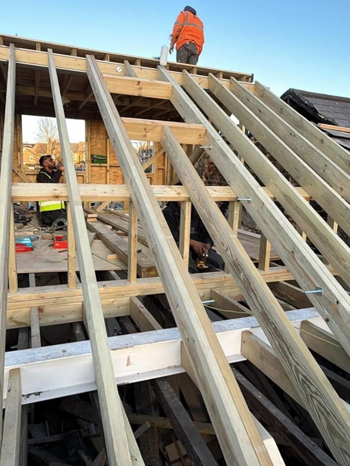 Timber roof rafters being installed.